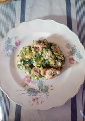 Una foto de Dados de pollo al verdeo con ensalada de lechuga, cebolla y brotes de lentejas