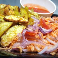 A picture of Baked Herbed Potatoes with kachumbari and sauce.