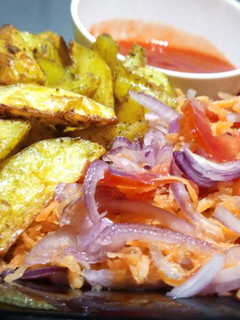 A picture of Baked Herbed Potatoes with kachumbari and sauce.