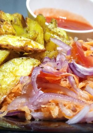 A picture of Baked Herbed Potatoes with kachumbari and sauce.