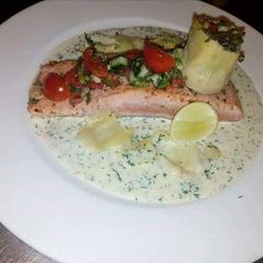 A picture of Fresh Salmon with dill sauce.