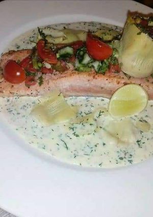 A picture of Fresh Salmon with dill sauce.