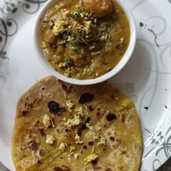 A picture of Dum aloo you with paneer paratha.