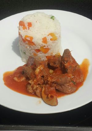 A picture of White rice with offals stew.