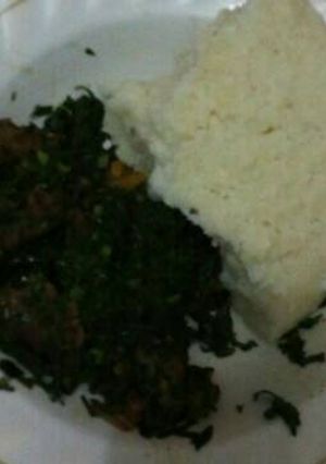 A picture of Ugari and green vegetables for two.