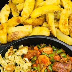 A picture of Baked potatoes and vegetable sauce.