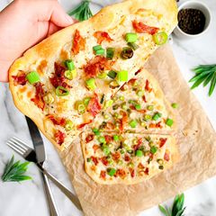 A picture of Spring onion and prosciutto flatbread.
