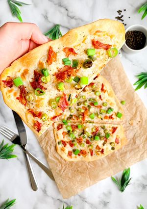 A picture of Spring onion and prosciutto flatbread.