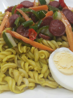 A picture of Pasta with egg,sausages and vegetables.