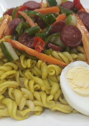 A picture of Pasta with egg,sausages and vegetables.