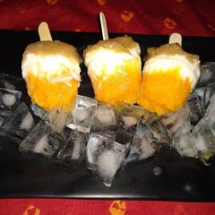 A picture of Grapes orange yogurt popsicles.