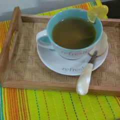 A picture of Chicken clear soup with blanch spinach and carrot.
