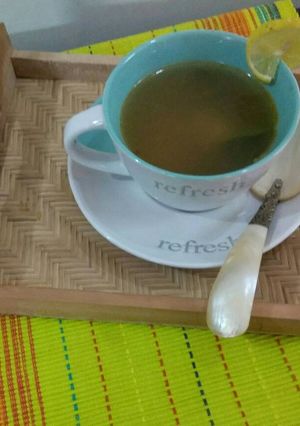 A picture of Chicken clear soup with blanch spinach and carrot.