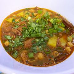 A picture of Spanish bean soup with smoked sausage and potato.