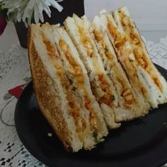 A picture of Tandoori chicken and potato sandwich.