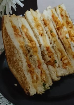 A picture of Tandoori chicken and potato sandwich.