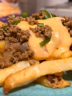 A picture of Cheesy fries with tawa keema.