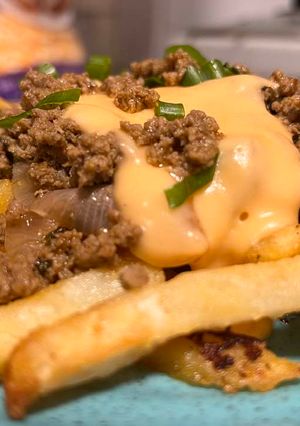 A picture of Cheesy fries with tawa keema.