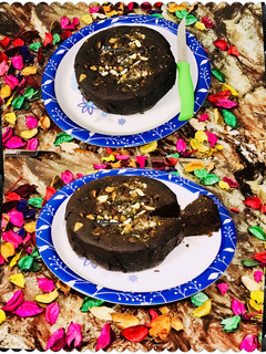 A picture of Eggless coffee & nuts plum cake in microwave.