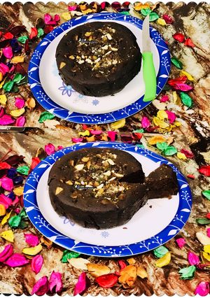 A picture of Eggless coffee & nuts plum cake in microwave.