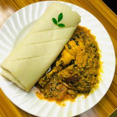 Egusi soup and rolled up pounded yam A picture of Egusi soup and rolled up pounded yam.