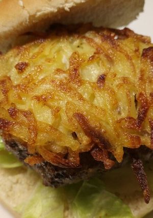 A picture of Fluffy's homemade hash brown cheese burger.