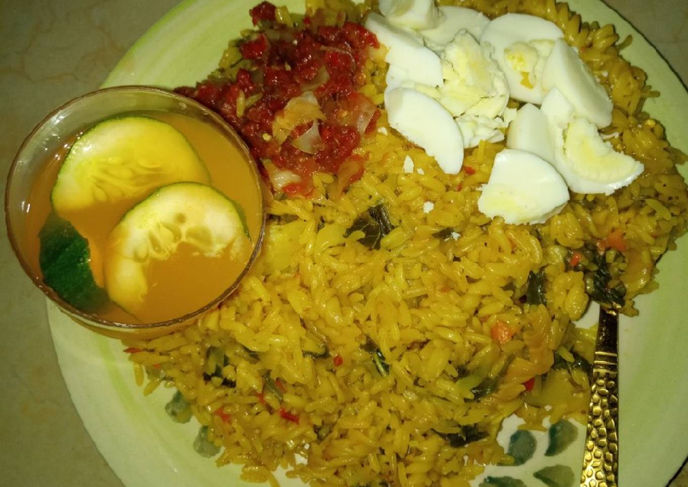 Jollof rice macaroni boiled egg en sauce and mango juice