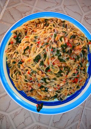A picture of Pasta with beans and moringa jellof.
