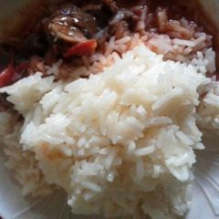 Beef stew Served with plain Rice A picture of Beef stew Served with plain Rice.