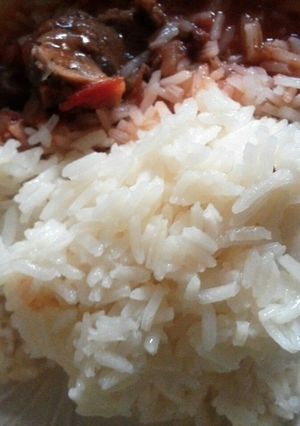 A picture of Beef stew Served with plain  Rice.