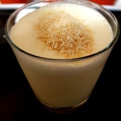 A picture of My Mango milk shake with grated coconut. 😊.