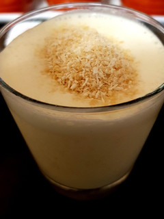 A picture of My Mango milk shake with grated coconut. 😊.