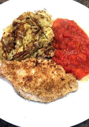 A picture of Pork Snitzel with Pan Fried Rosti & Tomato.