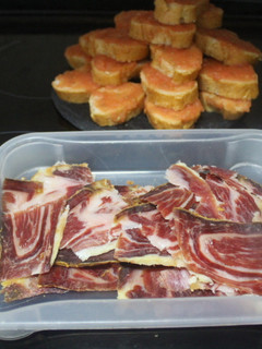 Una foto de Pan con tomate y jamón recién cortado