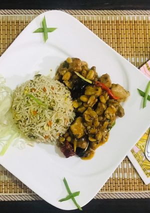 A picture of Kung pao chicken with egg fried rice.
