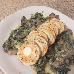 A picture of Chicken roulade with mushroom sauce.