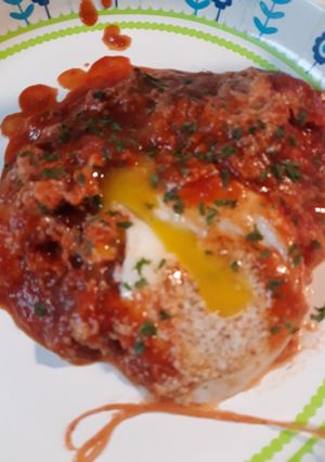 A picture of Chorizo and Eggs in a Cheesey Tomato Sauce.