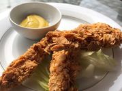 Una foto de pollo frito con mostaza