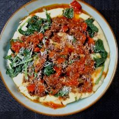 Beef brisket ragu with savoury semolina and wilted spinach A picture of Beef brisket ragu with savoury semolina and wilted spinach.