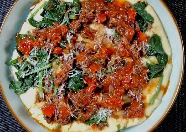 Homemade Beef brisket ragu with savoury semolina and wilted spinach