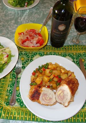 A picture of Chicken Breast Stuffed with Ham and Cheese. Peas and Potatoes.