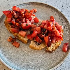 A picture of Marinated tomato on toast.
