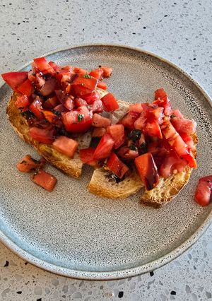 A picture of Marinated tomato on toast.