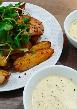 Una foto de Papas rústicas con salsa de Queso