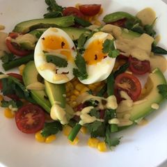 A picture of Asparagus, sweet corn, avocado and soft boiled egg salad.