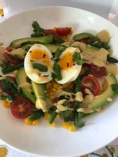 A picture of Asparagus, sweet corn, avocado and soft boiled egg salad.
