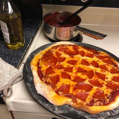 A picture of Pizza & tomato sauce.