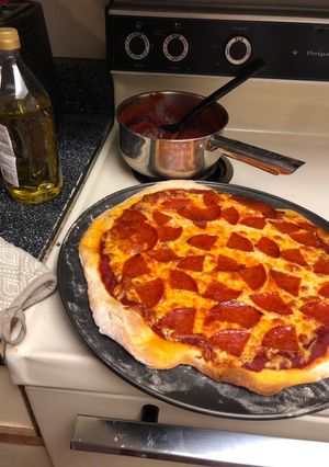 A picture of Pizza & tomato sauce.