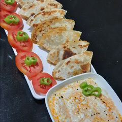 Jain Punjabi Chole Paratha with Dahi Tikhari A picture of Jain Punjabi Chole Paratha with Dahi Tikhari.