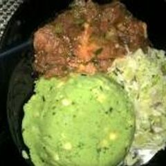 A picture of Mukimo served with wet fry beef and steamed cabbage.
